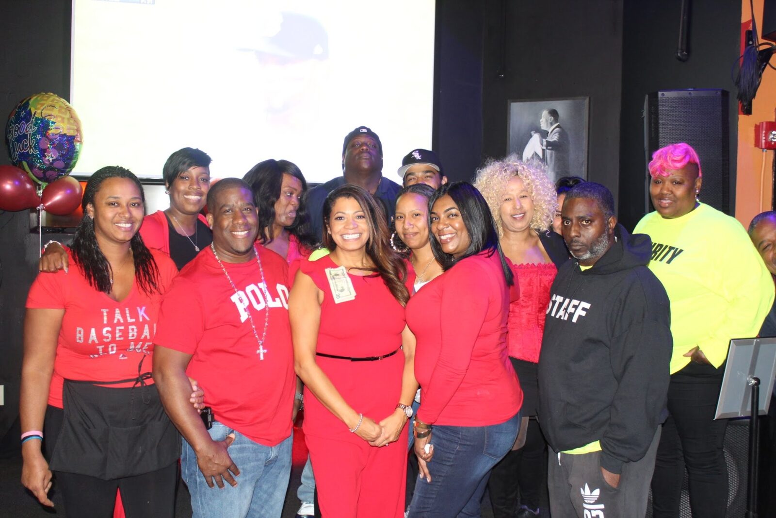 Slade's Bar and Grill staff team posing together in red at a private event in Boston
